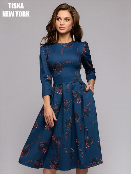 woman wearing navy blue knee length vintage printed dress with red stilettos-2