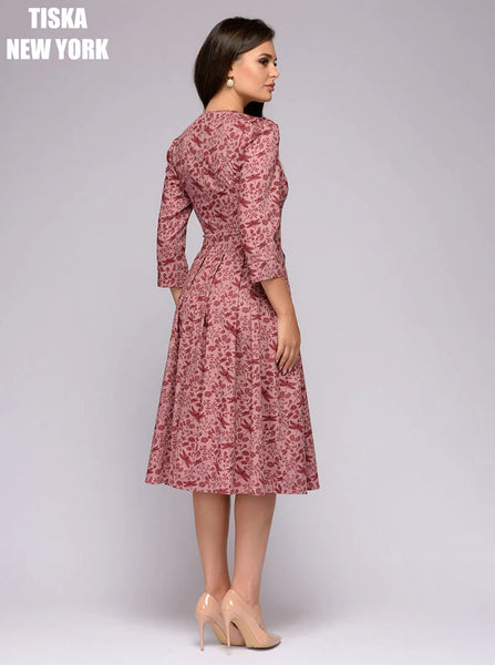 Woman wearing vintage peach colored printed dress sideways