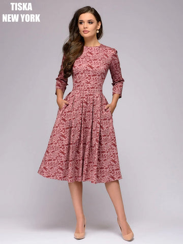 Woman wearing vintage peach colored printed dress