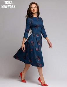 woman wearing navy blue knee length vintage printed dress with red stilettos