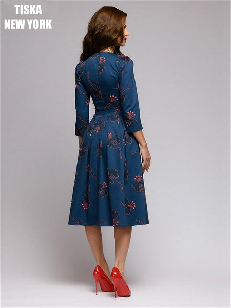 woman wearing navy blue knee length vintage printed dress with red stilettos-1